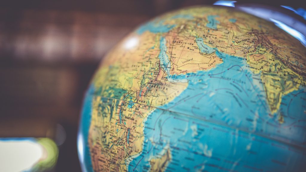 A globe sits on a desk.